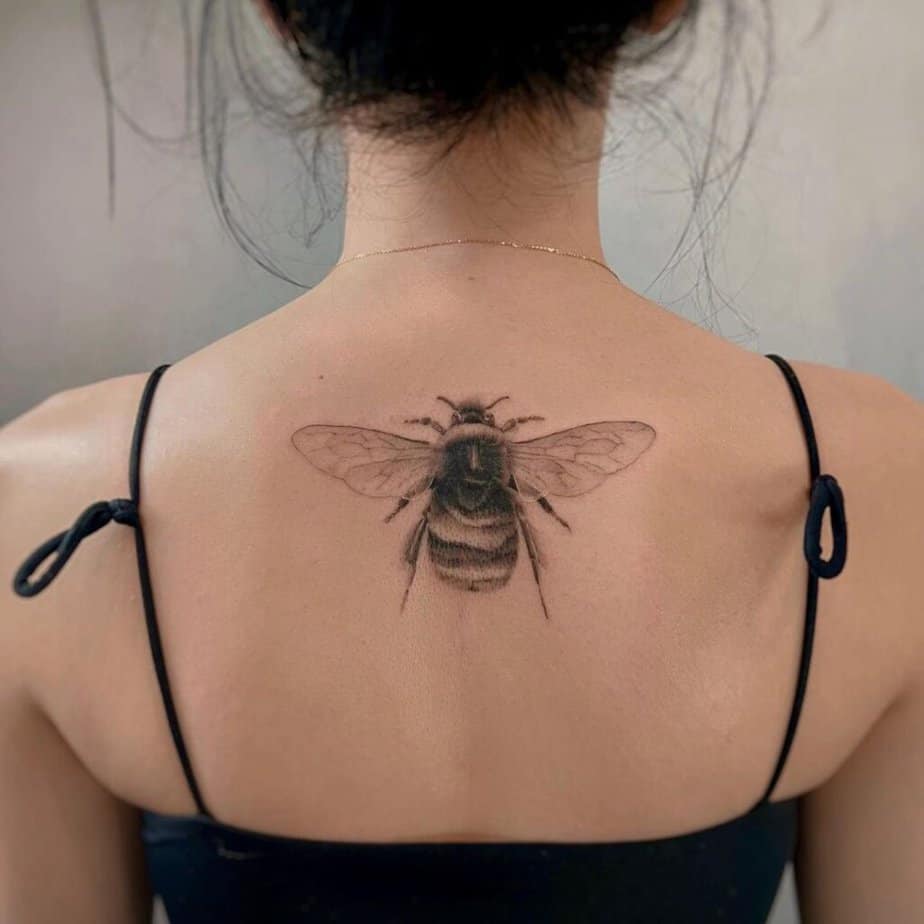 21. A bee tattoo on the back