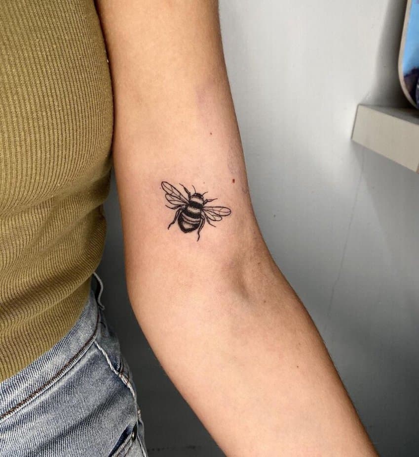 3. A cute bee tattoo on the inside of the arm