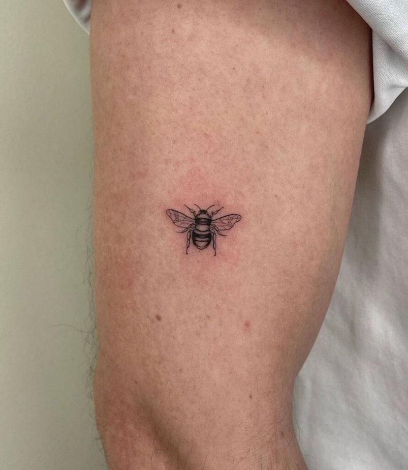 5. A bee tattoo on the upper arm