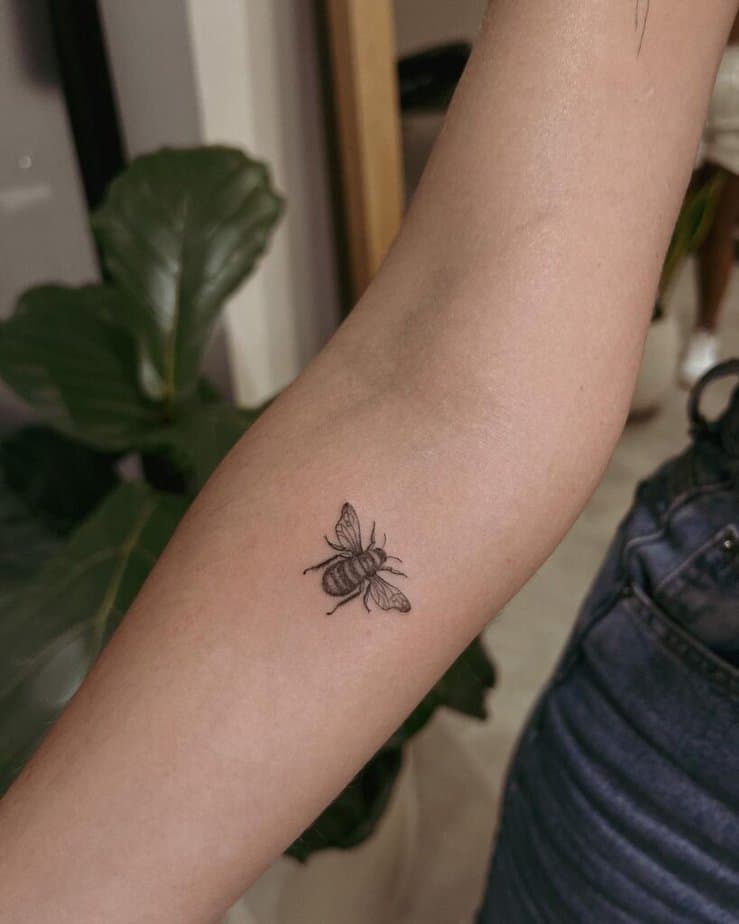 8. A fine-line bee tattoo