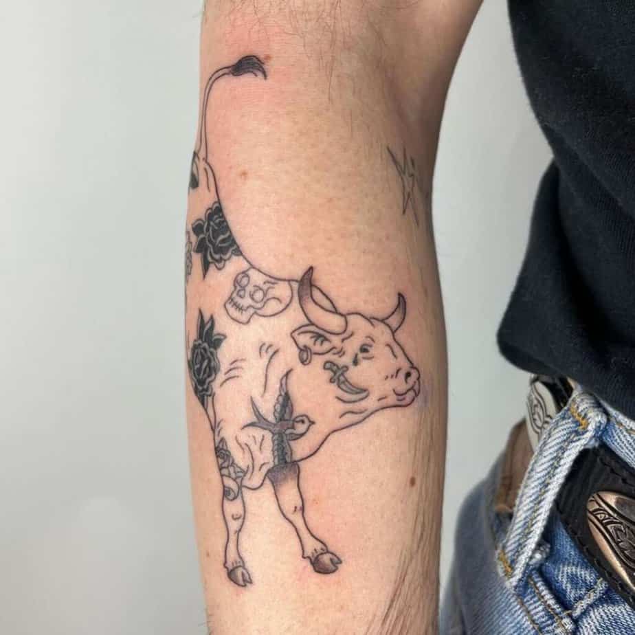 10. A tattoo of a cow with traditional tattoos