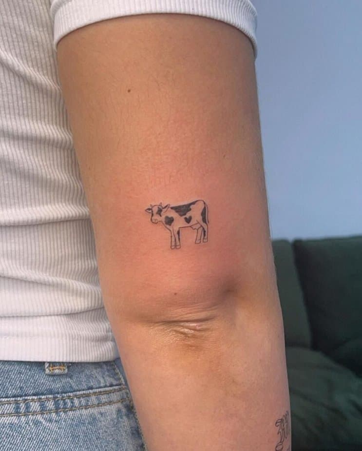 15. A small and simple cow tattoo 