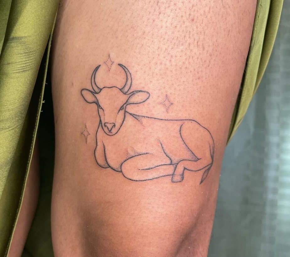 17. A dotwork cow tattoo on the thigh