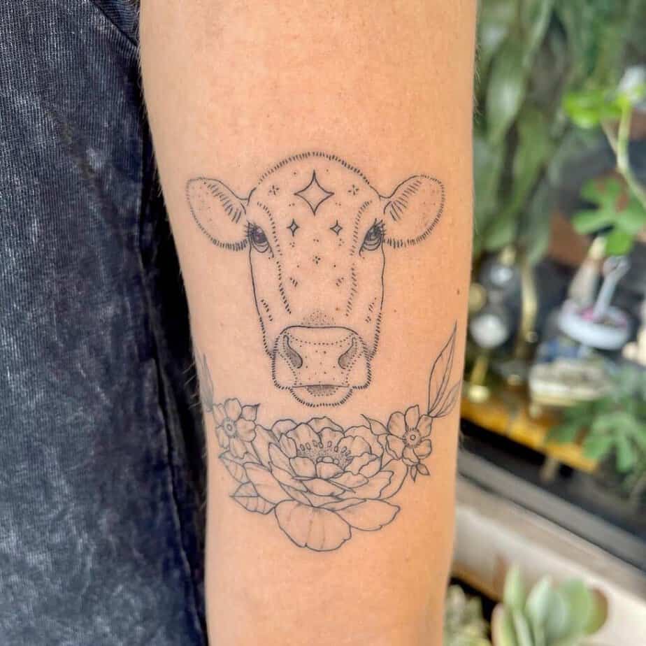 18. A cow head tattoo with flowers