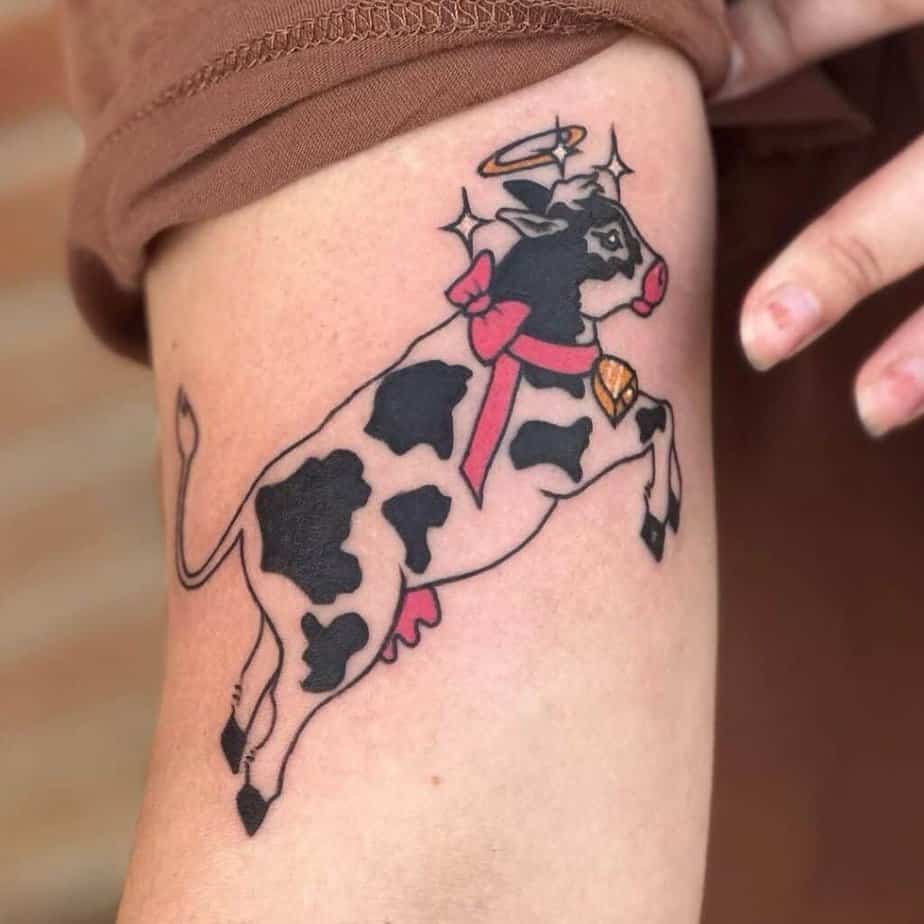 4. A tattoo of a cow with a pink bow