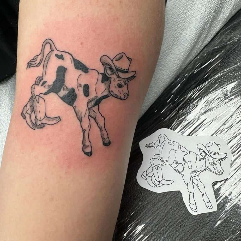 9. A tattoo of a cow wearing cowboy boots and a cowboy hat