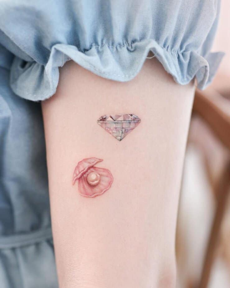 15. A pink pearl tattoo with a diamond
