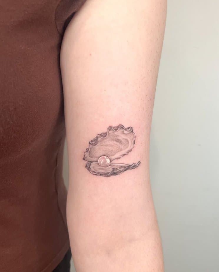 18. A soft and subtle oyster pearl tattoo 