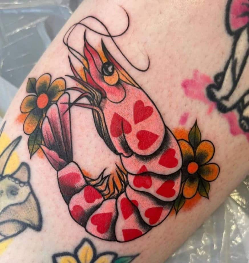 7. A traditional shrimp tattoo with hearts and flowers