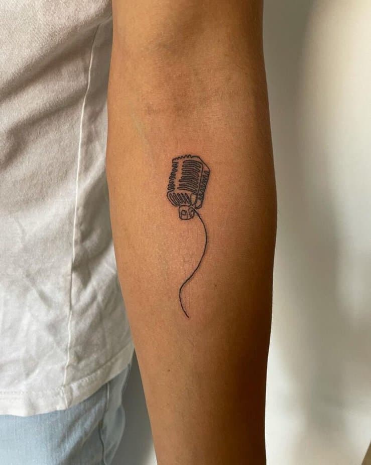 13. A linework microphone tattoo on the inside of the arm