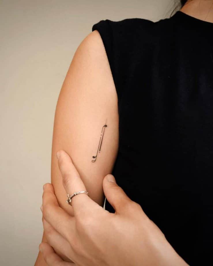 4. A music note tattoo on the upper arm