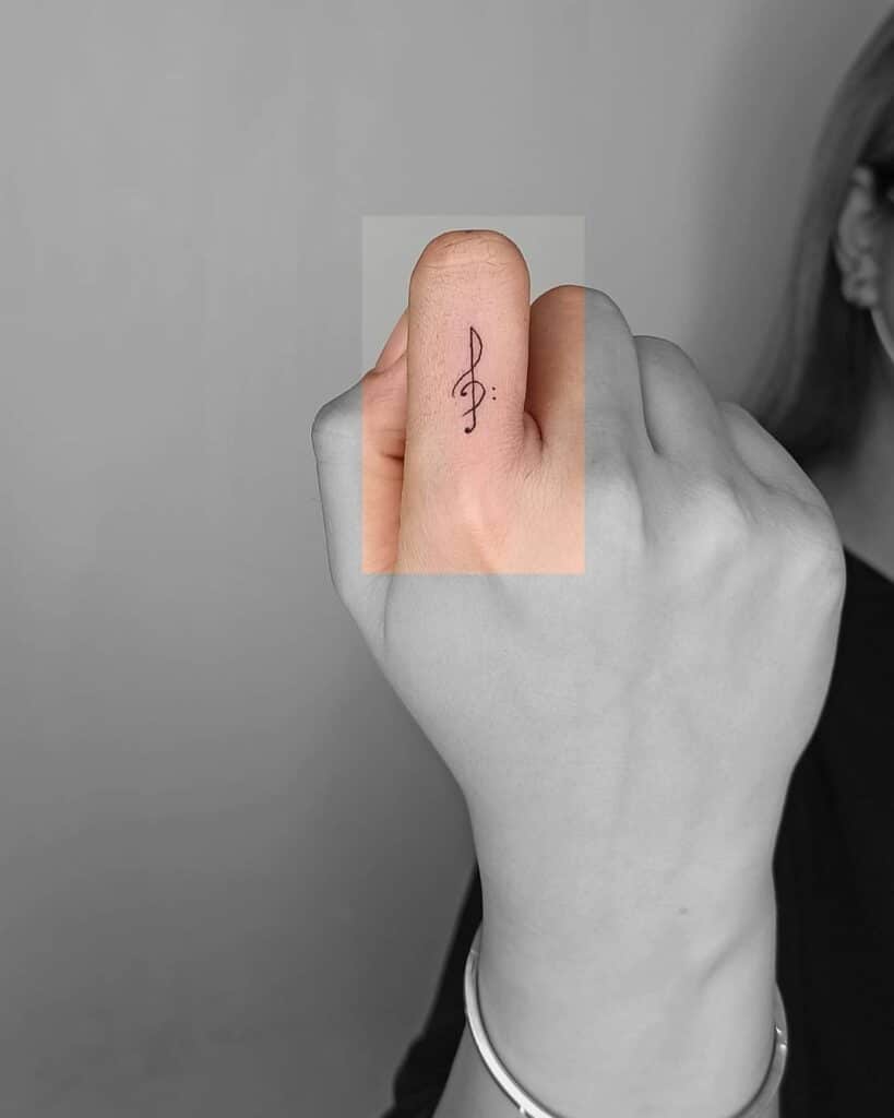 6. A treble clef tattoo on the finger