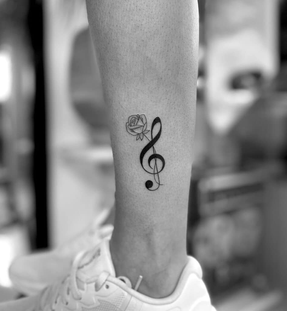 7. A treble clef tattoo above the ankle 