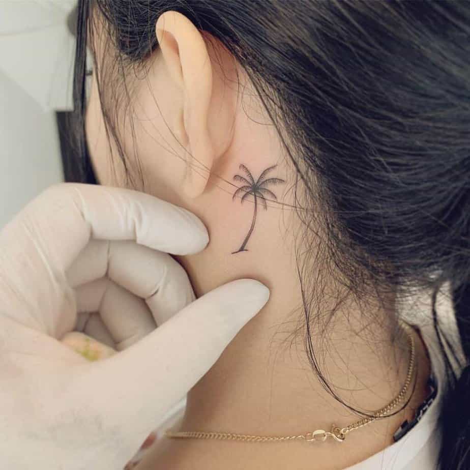 15. A behind-the-ear palm tree tattoo 