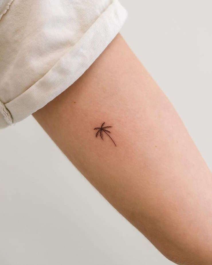 4. A delicate and dainty palm tree tattoo