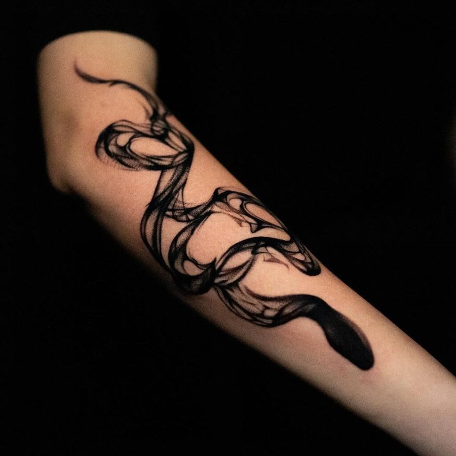 10. A smoke snake tattoo on the arm