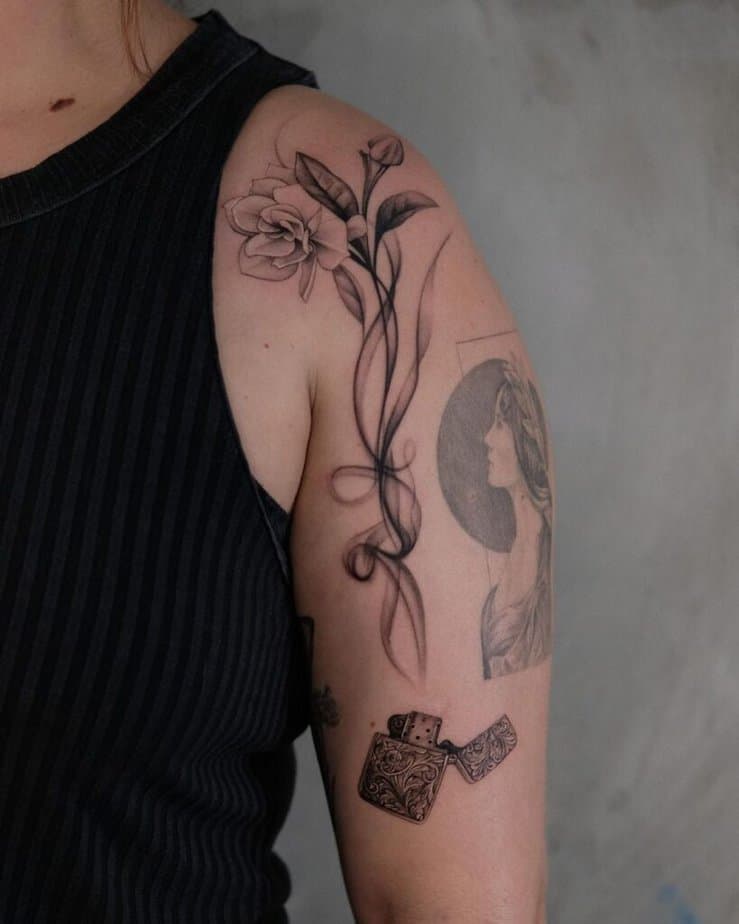 20. A smoke tattoo with a flower on the shoulder and arm 