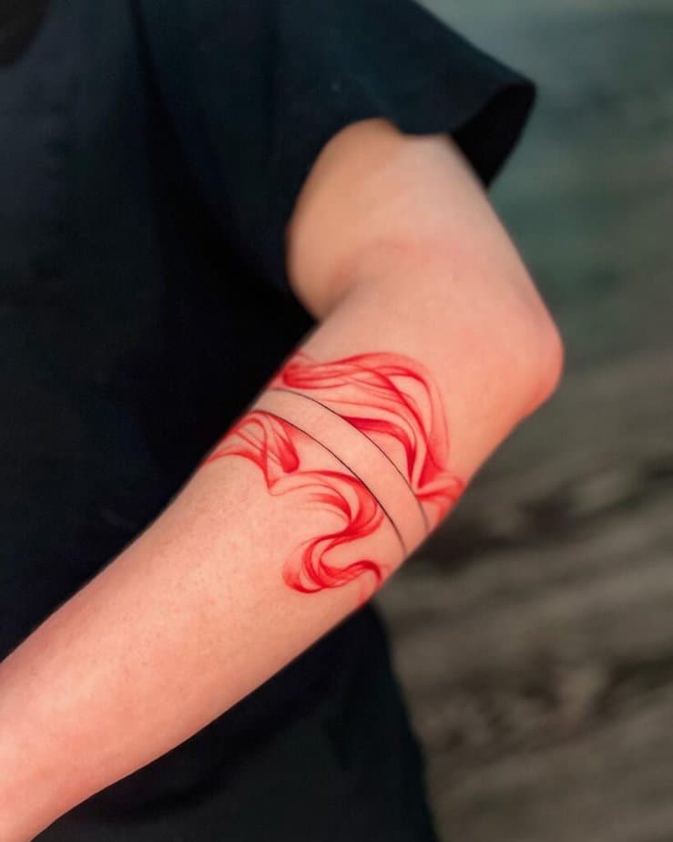 5. A red smoke tattoo on the forearm