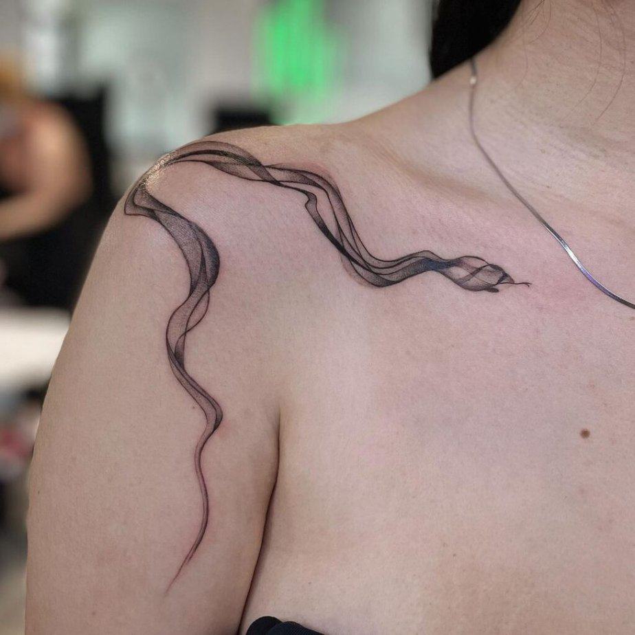 8. A smoke snake tattoo on the shoulder