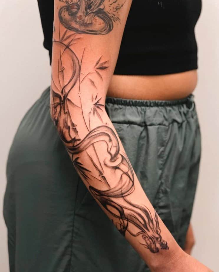 9. A smoke dragon tattoo on the arm