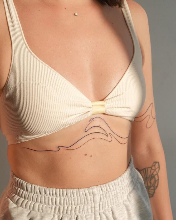 14. An abstract wave tattoo on the sternum 