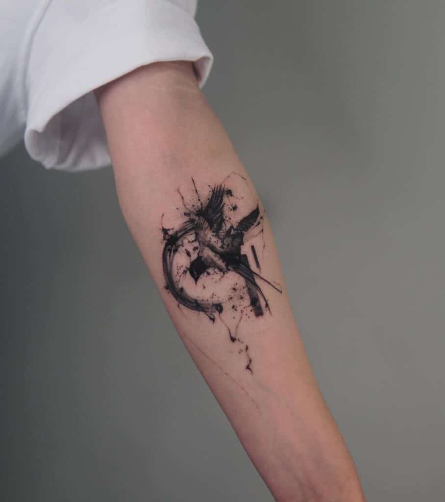 6. An abstract tattoo of a bird on the inside of the arm