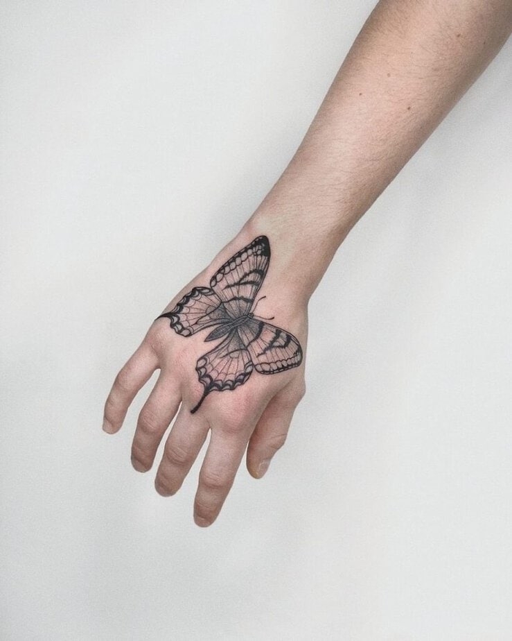 1. A big and bold butterfly hand tattoo 