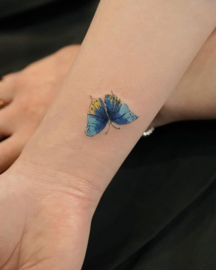 11. A watercolor butterfly hand tattoo 