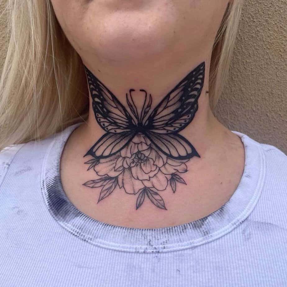 10. A front neck tattoo of a butterfly and a rose