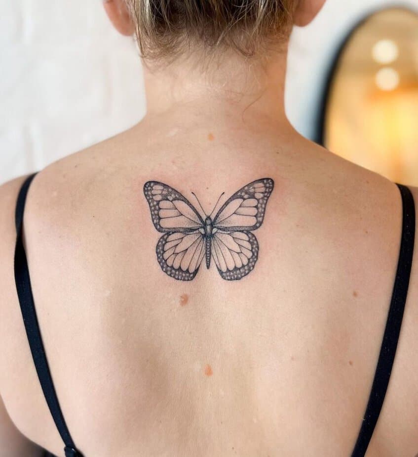 18. A soft butterfly tattoo right under the neck 