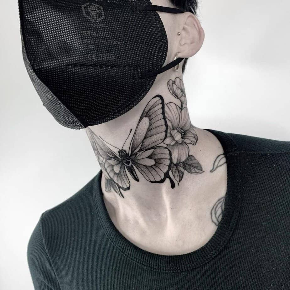4. A butterfly neck tattoo with flowers 