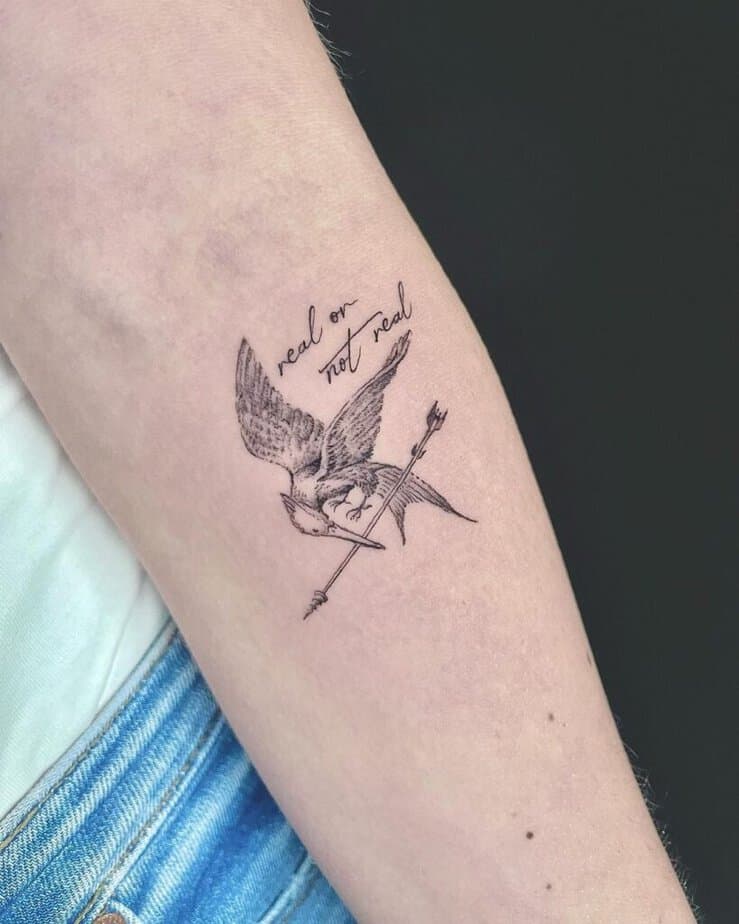 2. A Hunger Games tattoo with a quote 