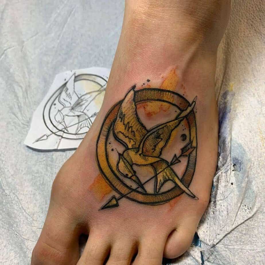 20. A Mockingjay symbol tattoo on the foot 