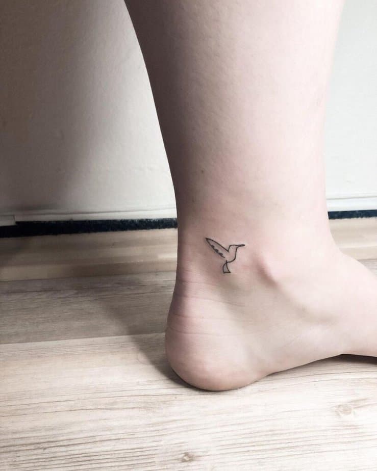 22. A line-art Mockingjay tattoo on the ankle 