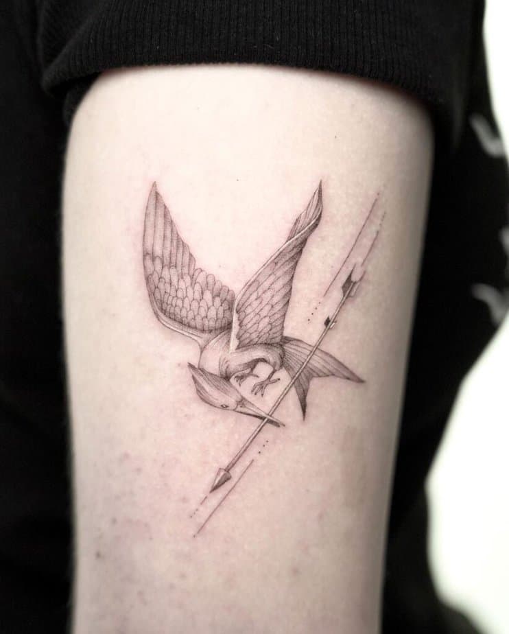 5. A fine-line Mockingjay tattoo 