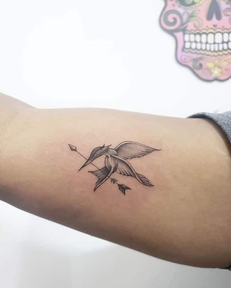 8. A Mockingjay tattoo on the upper arm