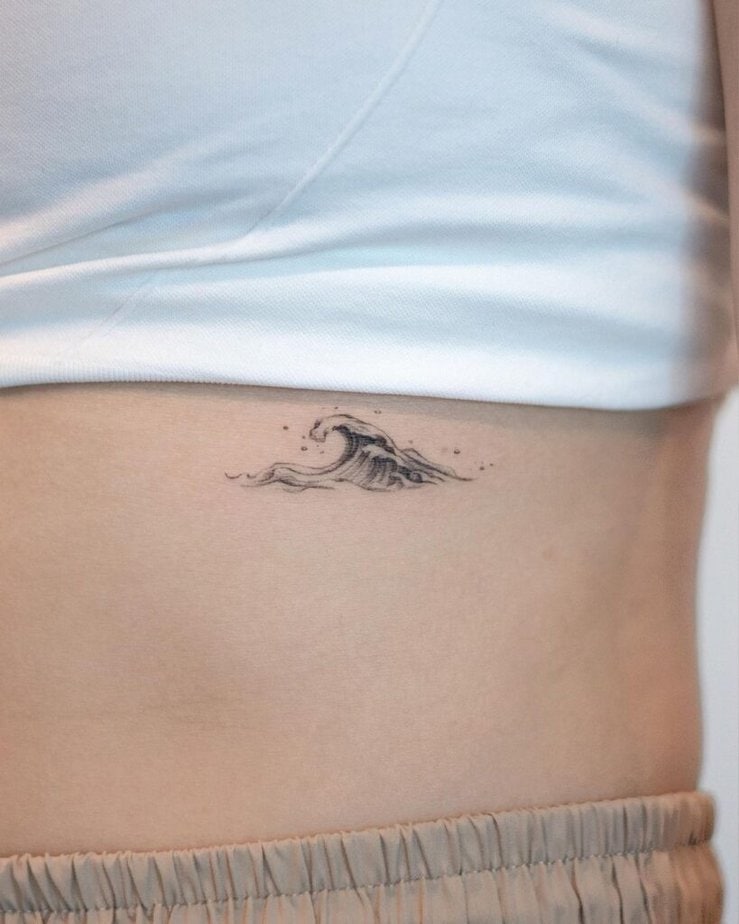 12. A tiny wave tattoo on the ribcage 
