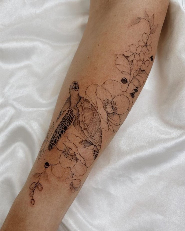 21. A tattoo of a turtle surrounded by flowers 