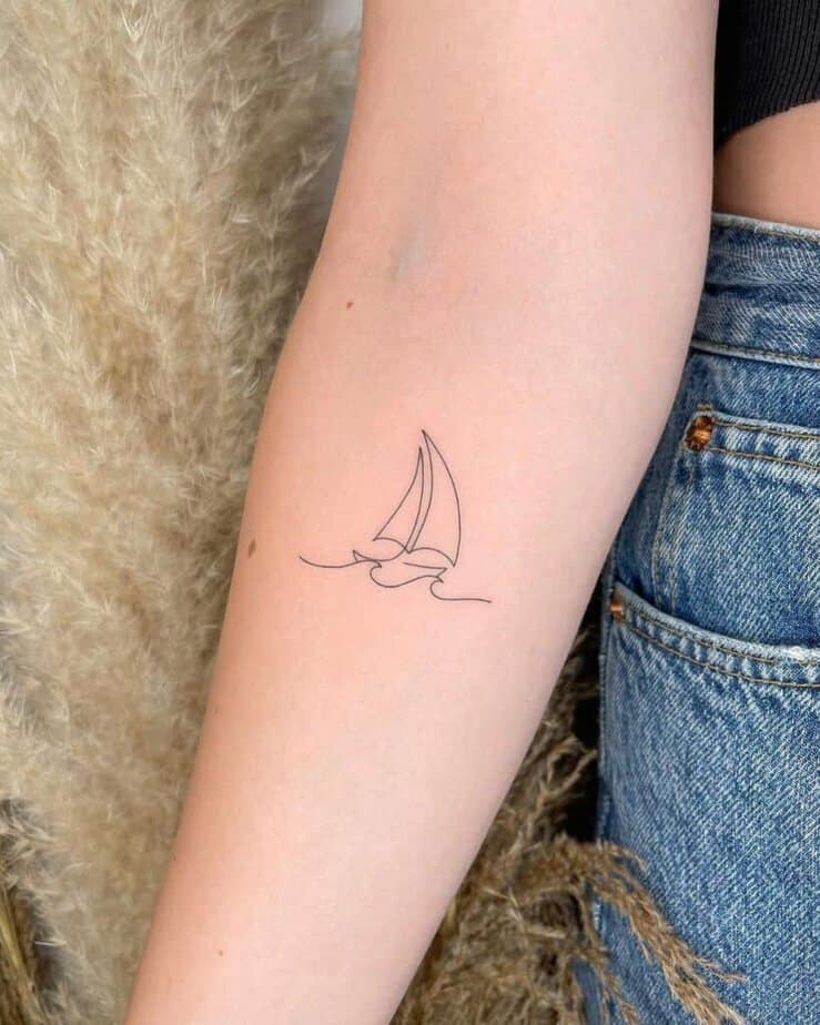 3. A line-art boat tattoo 