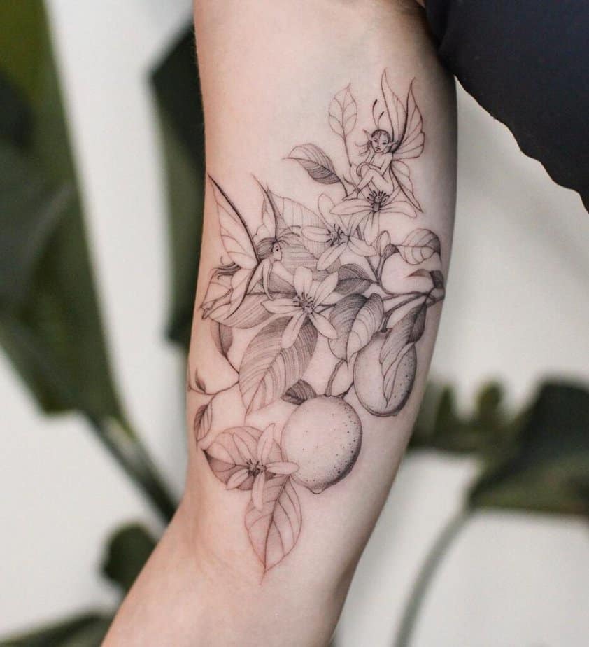 10. Tatuaggio di un ramo di limone con fate 