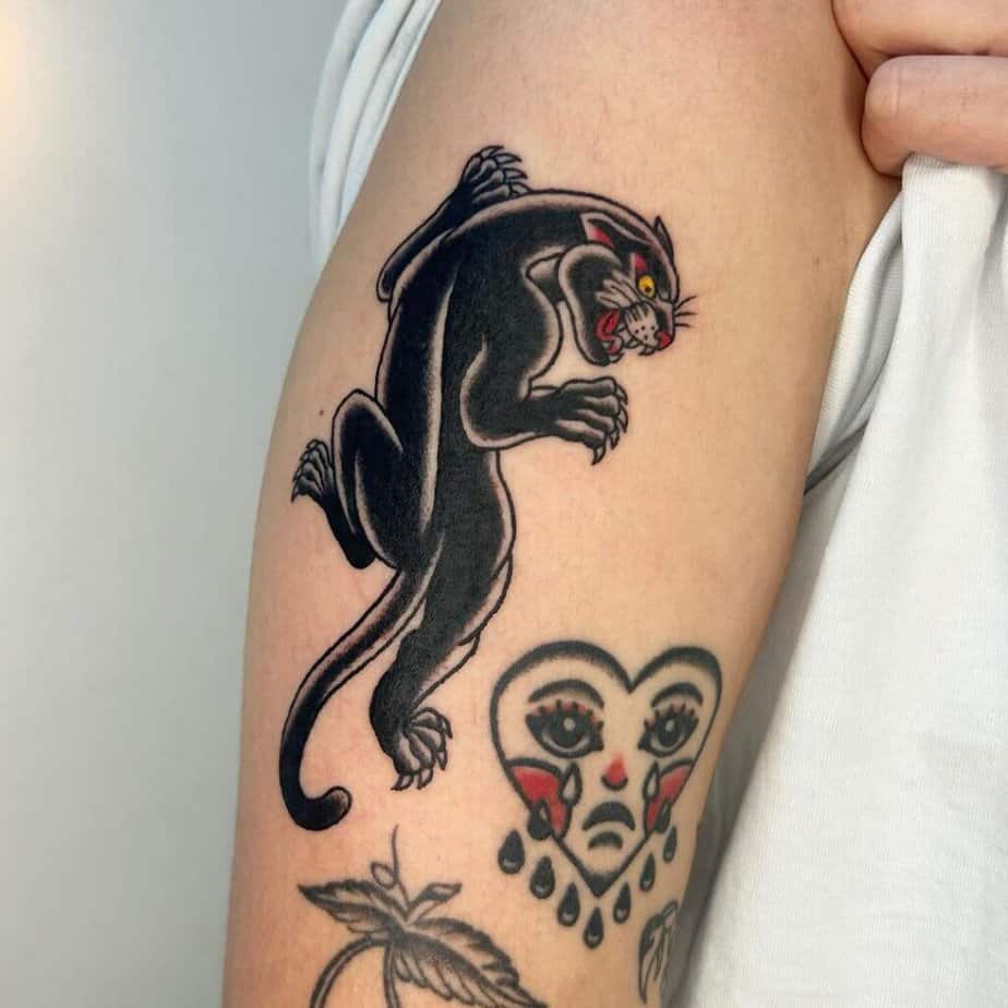 9. A panther tattoo on the upper arm