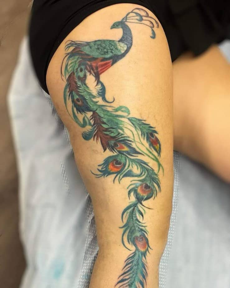 13. Thigh peacock tattoo
