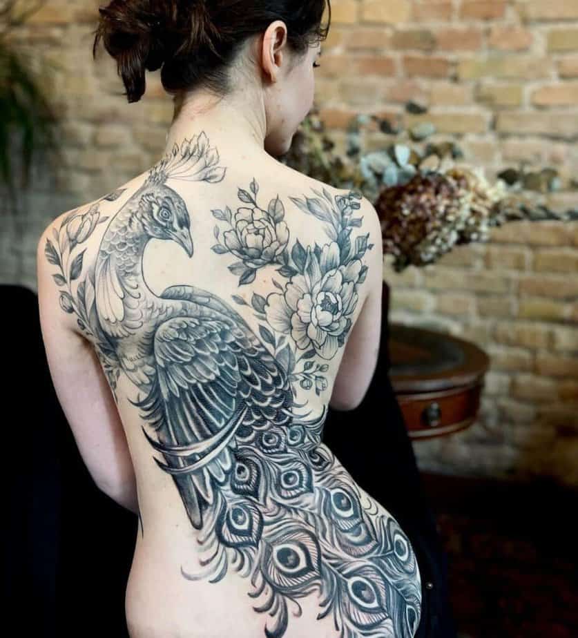 16. A black and grey back tattoo