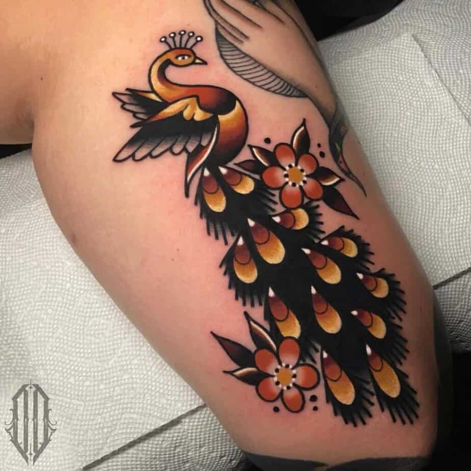 8. Golden peacock tattoo