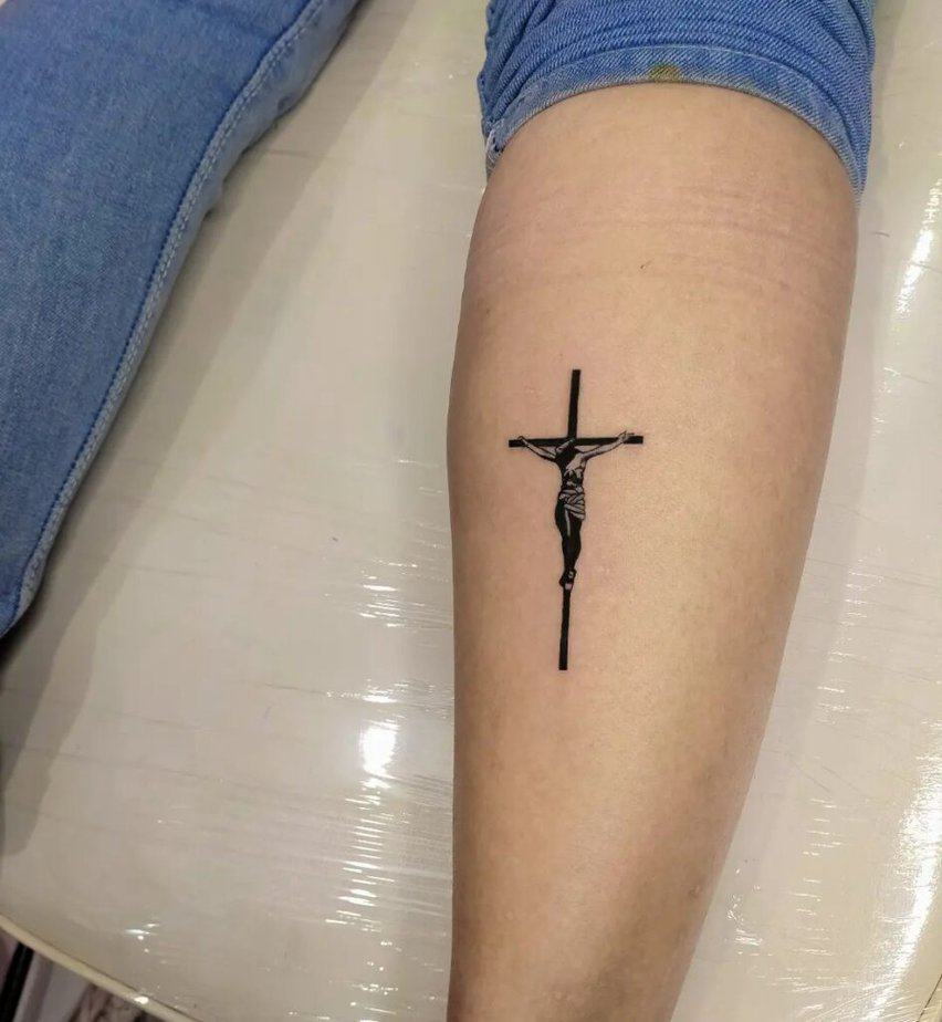 10. A forearm crucifix tattoo