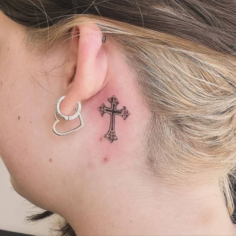 20. Cross tattoo behind the ear