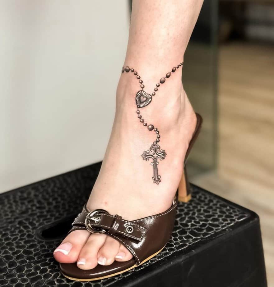 21. A rosary anklet tattoo