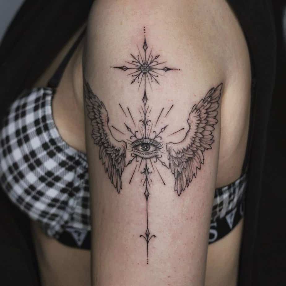 5. A guardian angel cross tattoo