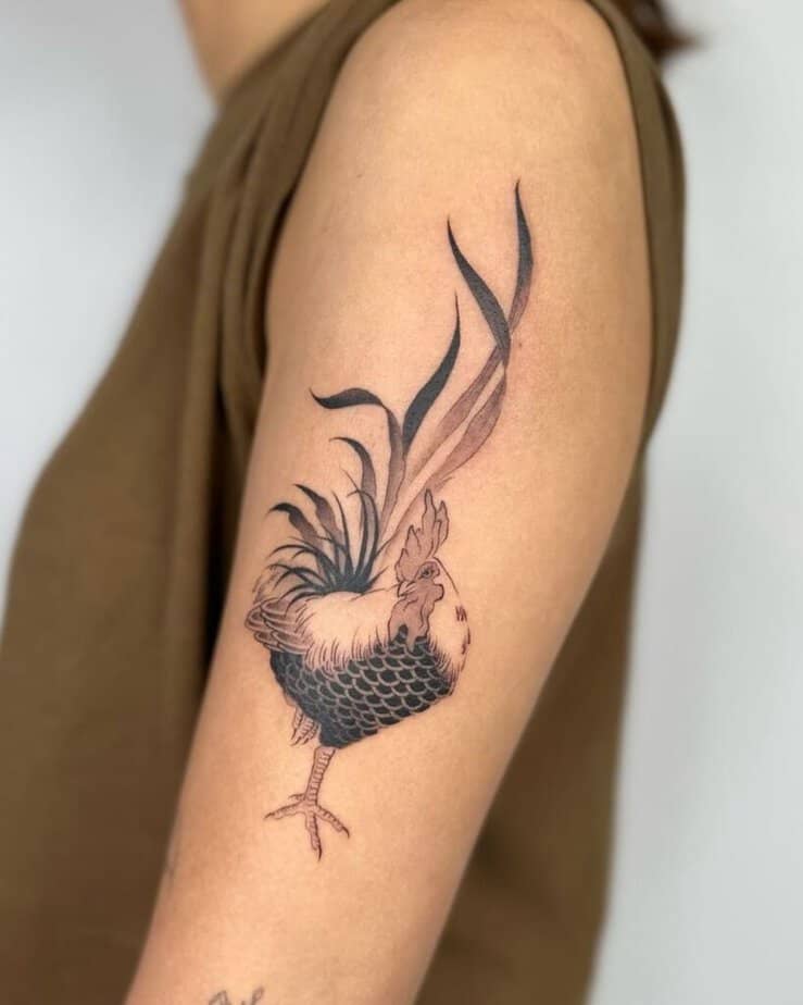 1. Un tatuaggio a forma di gallo sulla parte superiore del braccio