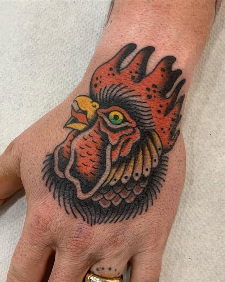 16. A rooster tattoo on the hand 
